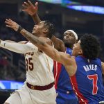 
              Cleveland Cavaliers' Isaac Okoro (35) drives to the basket against Detroit Pistons' Jerami Grant (9) and Killian Hayes (7) in the first half of an NBA basketball game, Friday, Nov. 12, 2021, in Cleveland. (AP Photo/Tony Dejak)
            