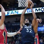 
              Minnesota Timberwolves center Karl-Anthony Towns (32) goes to the basket against New Orleans Pelicans center Willy Hernangomez (9) in the first half of an NBA basketball game in New Orleans, Monday, Nov. 22, 2021. (AP Photo/Gerald Herbert)
            