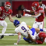 
              South Dakota State's Jadon Janke (9) fumbles the ball after getting tackled as South Dakota's Jack Cochrane (39) runs forward to catch the loose ball during an NCAA college football game, Saturday, Nov. 13, 2021, at the DakotaDome in Vermillion, S.D. (Erin Woodiel/The Argus Leader via AP)
            