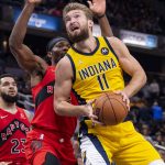 
              Indiana Pacers forward Domantas Sabonis (11) works the ball toward the basket during the second half of an NBA basketball game against the Toronto Raptors in Indianapolis, Friday, Nov. 26, 2021. (AP Photo/Doug McSchooler)
            