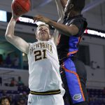 
              California forward Lars Thiemann (21) shoots past Florida guard Kowacie Reeves (14) during the second half of an NCAA college basketball game on Monday, Nov. 22, 2021, in Fort Myers, Fla. (AP Photo/Scott Audette)
            