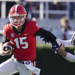 
              Georgia quarterback Carson Beck (15) tries to escape from Charleston Southern linebacker Kyle Syvarth (38) in the second half of an NCAA college football game Saturday, Nov. 20, 2021, in Athens, Ga.. (AP Photo/John Bazemore)
            