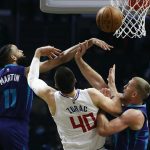 
              Los Angeles Clippers center Ivica Zubac (40) goes to basket under pressure from Charlotte Hornets forwards Cody Martin (11) and Mason Plumlee (24) during the first half of an NBA basketball game Sunday, Nov. 7, 2021, in Los Angeles. (AP Photo/Ringo H.W. Chiu)
            