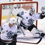 
              Seattle Kraken goaltender Chris Driedger (60) makes a glove save against the Florida Panthers during the first period of an NHL hockey game Saturday, Nov. 27, 2021, in Sunrise, Fla. (AP Photo/Jim Rassol)
            