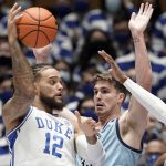
              Citadel forward Hayden Brown guards Duke forward Theo John (12) during the first half of an NCAA college basketball game in Durham, N.C., Monday, Nov. 22, 2021. (AP Photo/Gerry Broome)
            