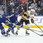 
              Pittsburgh Penguins' Jake Guentzel, right, gets a shot away for a first goal as Toronto Maple Leafs' Jake Muzzin, left, and Justin Holl trail during the first period of an NHL hockey game Saturday, Nov. 20, 2021, in Toronto. (Chris Young/The Canadian Press via AP)
            