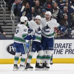 
              Vancouver Canucks' Tyler Motte, center, celebrates his goal against Columbus Blue Jackets with teammates Quinn Hughes, left, and Jason Dickinson during the second period of an NHL hockey game Friday, Nov. 26, 2021, in Columbus, Ohio. (AP Photo/Jay LaPrete)
            