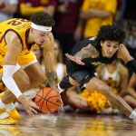 
              Iowa State guard Gabe Kalscheur (22) fights for a loose ball with Alabama State forward Trace Young, right, during the second half of an NCAA college basketball game, Tuesday, Nov. 16, 2021, in Ames, Iowa. (AP Photo/Charlie Neibergall)
            