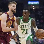 
              Boston Celtics' Dennis Schroder (71) drives against Cleveland Cavaliers' Dean Wade (32) in the first half of an NBA basketball game, Monday, Nov. 15, 2021, in Cleveland. (AP Photo/Tony Dejak)
            
