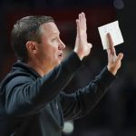 
              Florida head coach Mike White directs his players on the court during the first half of an NCAA college basketball game against Florida State, Sunday, Nov. 14, 2021, in Gainesville, Fla. (AP Photo/John Raoux)
            