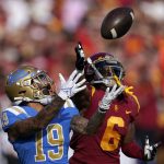 
              UCLA running back Kazmeir Allen, left, makes a touchdown catch as Southern California cornerback Isaac Taylor-Stuart defends during the first half of an NCAA college football game Saturday, Nov. 20, 2021, in Los Angeles. (AP Photo/Mark J. Terrill)
            