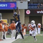 
              West Virginia wide receiver Kaden Prather (3) reaches for a pass as Texas defensive back B.J. Foster (25) moves in during the first half of an NCAA college football game in Morgantown, W.Va., Saturday, Nov. 20, 2021. (AP Photo/Kathleen Batten)
            