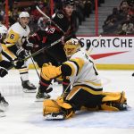 
              The puck flies past Pittsburgh Penguins goaltender Casey DeSmith (1) as Pierre-Olivier Joseph (73) and Ottawa Senators' Drake Batherson (19) watch during the second period of an NHL hockey game in Ottawa, on Saturday, Nov. 13, 2021. (Justin Tang/The Canadian Press via AP)
            