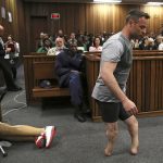 
              FILE - Olympic runner Oscar Pistorius' prosthetics lay on the floor as he walks on his amputated legs during argument in mitigation of sentence by his defence attorney Barry Roux in the High Court in Pretoria where he appeared for the murder of his girlfriend Reeva Steenkamp, on June 15, 2016. Eight years after he shot dead his girlfriend, Pistorius is up for parole, but first he must meet with her parents as part of the parole procedure. A parole hearing for Pistorius was scheduled for last month and then canceled, partly because a meeting between Pistorius and Steenkamp's parents, Barry and June, had not been arranged, lawyers for both parties told The Associated Press on Monday, Nov. 8, 2021. (Siphiwe Sibeko via AP, Pool,File)
            
