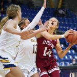 
              Indiana guard Ali Patberg (14) drives to the basket against Quinnipiac's Rose Caverly (12) and Mikala Morris during the first half of an NCAA college basketball game Saturday, Nov. 20, 2021, in Hamden, Conn. (AP Photo/Bryan Woolston)
            
