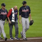 
              ADDS NAME OF BRAVES TRAINER AT CENTER AND BRAVES MANAGER AT LEFT- Atlanta Braves starting pitcher Charlie Morton, right, is helped off the field by Braves head athletic trainer George Poulis, center, during the third inning of Game 1 in baseball's World Series between the Houston Astros and the Atlanta Braves Tuesday, Oct. 26, 2021, in Houston. At left is Braves manager Brian Snitker. AP Photo/Eric Gay)
            