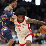 
              Houston Rockets guard Kevin Porter Jr. (3) drives to the basket against Denver Nuggets guard Monte Morris (11) during the first half of an NBA basketball game Saturday, Nov. 6, 2021, in Denver. (AP Photo/Jack Dempsey)
            