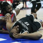 
              Brooklyn Nets guard James Harden (13) and Detroit Pistons center Isaiah Stewart (28) fall under the basket during the first half of an NBA basketball game, Friday, Nov. 5, 2021, in Detroit. (AP Photo/Carlos Osorio)
            