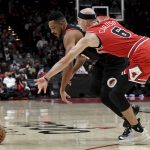 
              Portland Trail Blazers guard CJ McCollum, left, and Chicago Bulls guard Alex Caruso go after the ball during the first half of an NBA basketball game in Portland, Ore., Wednesday, Nov. 17, 2021. (AP Photo/Steve Dykes)
            