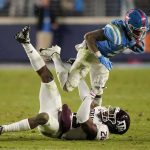 
              Mississippi running back Jerrion Ealy (9) leaps over Texas A&M defensive back Demani Richardson (26) during the first half of an NCAA college football game, Saturday, Nov. 13, 2021, in Oxford, Miss. (AP Photo/Rogelio V. Solis)
            