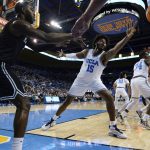 
              UCLA center Myles Johnson (15) tries to block an inbound pass by Long Beach State guard Drew Cobb, left, during the first half of an NCAA college basketball game in Los Angeles, Monday, Nov. 15, 2021. (AP Photo/Ashley Landis)
            