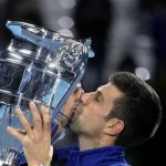 
              Serbia's Novak Djokovic kisses the trophy as ATP world best player, at the Tennis ATP World Tour Finals, at the Pala Alpitour in Turin, Monday, Nov. 15, 2021. (AP Photo/Luca Bruno)
            