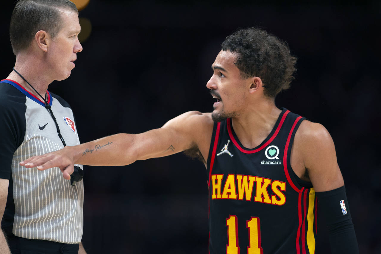 Atlanta Hawks guard Trae Young (11) talks with an official during the second half of an NBA basketb...