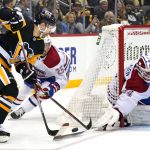 
              Montreal Canadiens goaltender Jake Allen (34) knocks the puck off the stick of Pittsburgh Penguins' Jason Zucker, left, with Canadiens' Ryan Poehling (25) defending during the second period of an NHL hockey game in Pittsburgh, Saturday, Nov. 27, 2021. (AP Photo/Gene J. Puskar)
            
