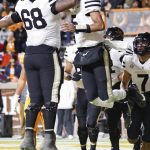 
              Vanderbilt quarterback Mike Wright (5) celebrates scoring a touchdown with offensive lineman Jason Brooks Jr. (68) during the second half of an NCAA college football game against Tennessee Saturday, Nov. 27, 2021, in Knoxville, Tenn. (AP Photo/Wade Payne)
            