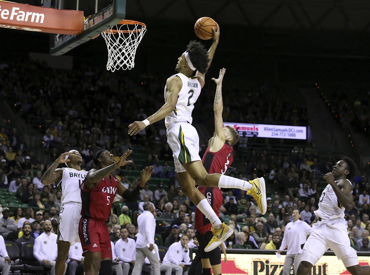 Baylor guard Kendall Brown (2) dunks past Incarnate Word guard Drew Lutz (3) in the second half of ...