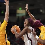 
              South Carolina forward Aliyah Boston (4) is defended by North Carolina A&T center Jazmin Harris, right, and Kiana Adderton (11) during the first half of an NCAA college basketball game Monday, Nov. 29, 2021, in Columbia, S.C. (AP Photo/Sean Rayford)
            