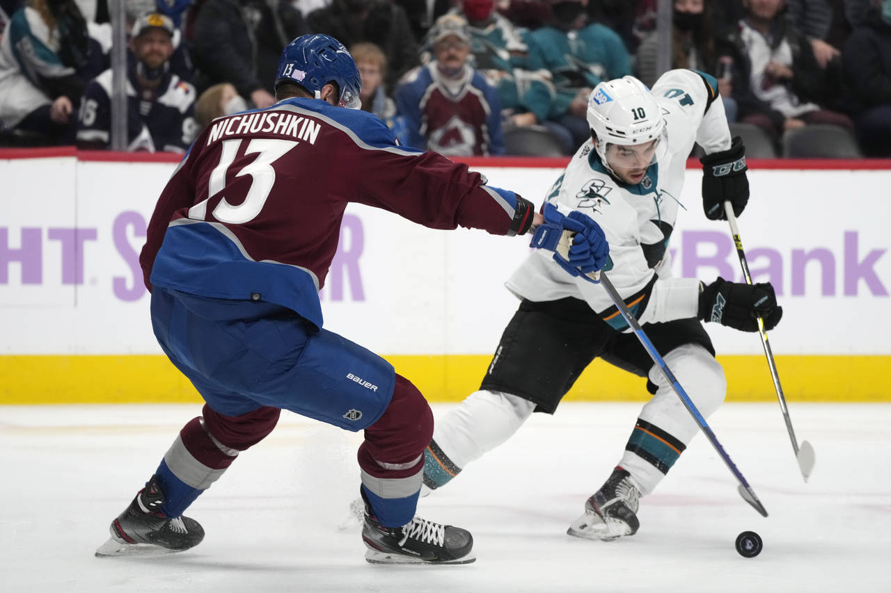 San Jose Sharks right wing Nick Merkley, right, picks up the puck as Colorado Avalanche right wing ...