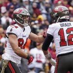 
              Tampa Bay Buccaneers tight end Cameron Brate (84) and quarterback Tom Brady (12) celebrate after connecting for a touchdown during the second half of an NFL football game against the Washington Football Team, Sunday, Nov. 14, 2021, in Landover, Md. (AP Photo/Patrick Semansky)
            