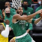 
              Boston Celtics' Jayson Tatum (0) goes up to shoot against Los Angeles Lakers' LeBron James, left, during the first half of an NBA basketball game, Friday, Nov. 19, 2021, in Boston. (AP Photo/Michael Dwyer)
            
