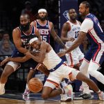 
              New York Knicks guard Immanuel Quickley, center, and Brooklyn Nets guard James Harden (13) fight for a loose ball during the second half of an NBA basketball game, Tuesday, Nov. 30, 2021, in New York. The Nets won 112-110. (AP Photo/Mary Altaffer)
            