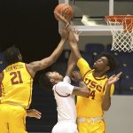 
              Southern California guard Reese Dixon-Waters, left, and forward Joshua Morgan reach to block a shot by Saint Joseph's guard Cameron Brown in the first half on an NCAA college basketball game against Saint Joseph's at the Wooden Legacy tournament in Anaheim, Calif., Thursday, Nov. 25, 2021. (AP Photo/Jayne Kamin-Oncea)
            