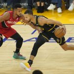
              Golden State Warriors guard Stephen Curry, right, drives to the basket against Portland Trail Blazers guard CJ McCollum during the first half of an NBA basketball game in San Francisco, Friday, Nov. 26, 2021. (AP Photo/Jeff Chiu)
            