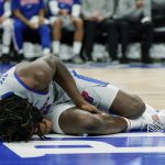 
              Detroit Pistons center Isaiah Stewart grimaces on the floor after a play during the second half of an NBA basketball game against the Golden State Warriors, Friday, Nov. 19, 2021, in Detroit. Stewart was helped off the court. (AP Photo/Carlos Osorio)
            