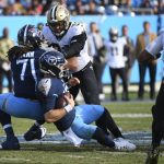 
              Tennessee Titans quarterback Ryan Tannehill (17) is sacked as New Orleans Saints defensive end Marcus Davenport (92) pushes Titans offensive tackle Kendall Lamm (71) into Tannehill in the second half of an NFL football game Sunday, Nov. 14, 2021, in Nashville, Tenn. (AP Photo/John Amis)
            