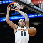 
              Denver Nuggets forward Aaron Gordon dunks against the Phoenix Suns during the first half of an NBA basketball game Sunday, Nov. 21, 2021, in Phoenix. (AP Photo/Ross D. Franklin)
            