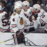 
              Chicago Blackhawks defenseman Seth Jones (4) greets teammates after he scored a goal against the Seattle Kraken during the first period of an NHL hockey game, Wednesday, Nov. 17, 2021, in Seattle. (AP Photo/Ted S. Warren)
            