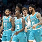 
              From left to right, Charlotte Hornets forward Cody Martin (11), forward Jalen McDaniels (6), guard LaMelo Ball (2), guard Terry Rozier (3) and forward Miles Bridges (0) celebrate as they walk to the bench during the second half of an NBA basketball game against the Golden State Warriors, Sunday, Nov. 14, 2021, in Charlotte, N.C. (AP Photo/Matt Kelley)
            