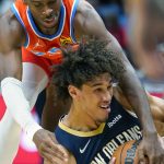
              New Orleans Pelicans center Jaxson Hayes, below, battles for a loose ball with Oklahoma City Thunder guard Shai Gilgeous-Alexander in the first half of an NBA basketball game in New Orleans, Wednesday, Nov. 10, 2021. (AP Photo/Gerald Herbert)
            