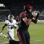 
              San Diego State tight end Daniel Bellinger catches a touchdown pass in front of Nevada defensive back Berdale Robins during the first half of an NCAA college football game Saturday, Nov. 13, 2021, in Carson, Calif. (AP Photo/Jae C. Hong)
            
