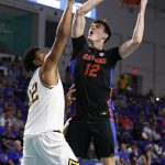 
              Florida forward Colin Castleton (12) drives to the basket past California forward Andre Kelly (22) during the first half of an NCAA college basketball game on Monday, Nov. 22, 2021, in Fort Myers, Fla. (AP Photo/Scott Audette)
            