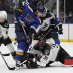 
              Arizona Coyotes goaltender Scott Wedgewood dives for the puck as St. Louis Blues' James Neal (81) tries to poke it free, while Coyotes' Jakob Chychrun (6) helps defend during the second period of an NHL hockey game Tuesday, Nov. 16, 2021 in St. Louis. (AP Photo/Tom Gannam)
            
