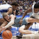 
              Duke forward Wendell Moore Jr., left, and guard Trevor Keels struggle with Citadel guard Tyler Moffe (13) during the first half of an NCAA college basketball game in Durham, N.C., Monday, Nov. 22, 2021. (AP Photo/Gerry Broome)
            