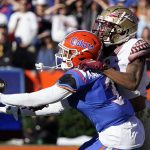 
              Florida cornerback Jason Marshall Jr., left, intercepts a pass intended for Florida State wide receiver Andrew Parchment during the second half of an NCAA college football game, Saturday, Nov. 27, 2021, in Gainesville, Fla. (AP Photo/John Raoux)
            
