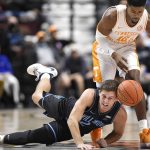 
              Villanova's Collin Gillespie (2) and Tennessee's Victor Bailey Jr. (12) battle for a loose ball in the first half of an NCAA college basketball game, Saturday, Nov. 20, 2021, in Uncasville, Conn. (AP Photo/Jessica Hill)
            