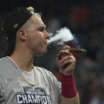 
              Atlanta Braves right fielder Joc Pederson celebrates with a cigar after winning baseball's World Series in Game 6 against the Houston Astros Tuesday, Nov. 2, 2021, in Houston. The Braves won 7-0. (AP Photo/David J. Phillip)
            
